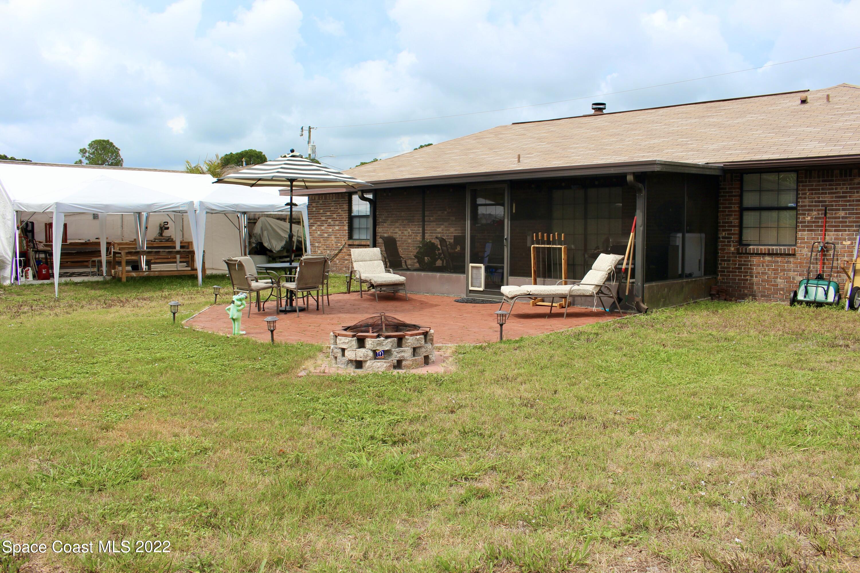 6737 Cecil Road Cocoa, FL 32927 - Photo 32 of 39 a view of a house with backyard porch and sitting area