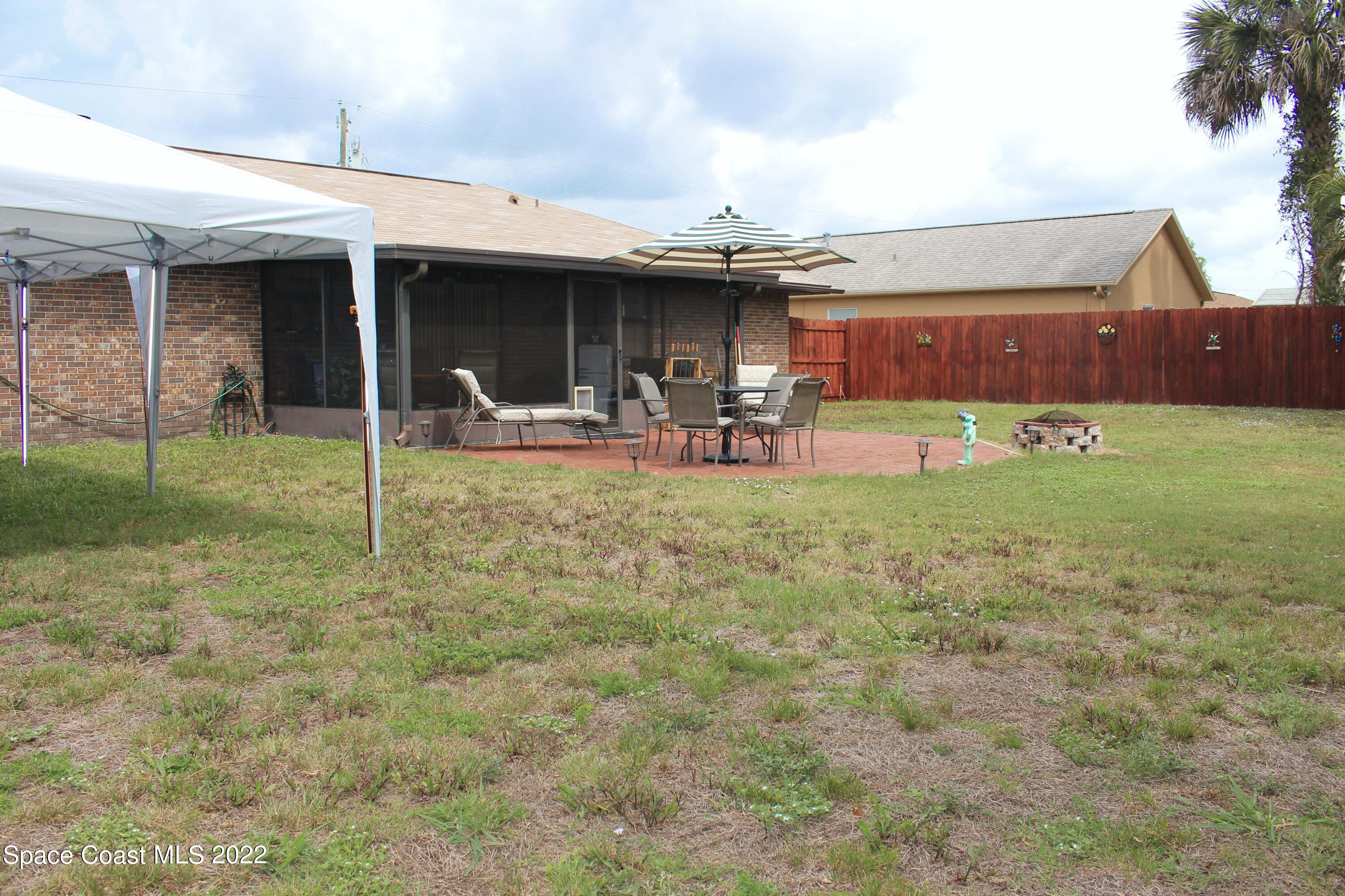 6737 Cecil Road Cocoa, FL 32927 - Photo 36 of 39 a view of a house with backyard porch and sitting area