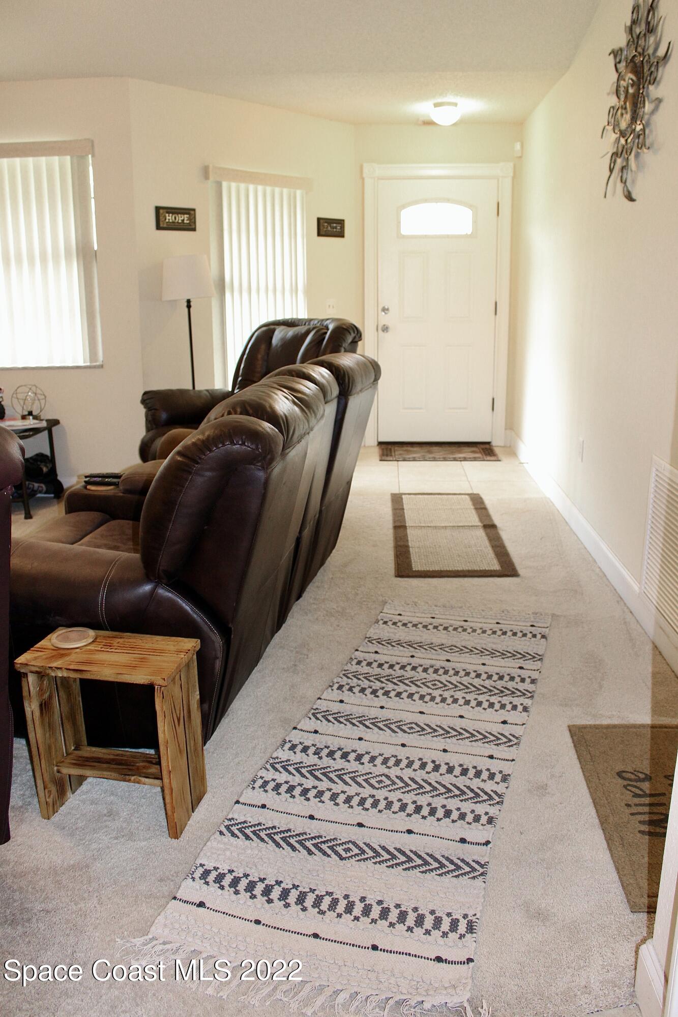 6737 Cecil Road Cocoa, FL 32927 - Photo 4 of 39 a living room with a couch and a rug