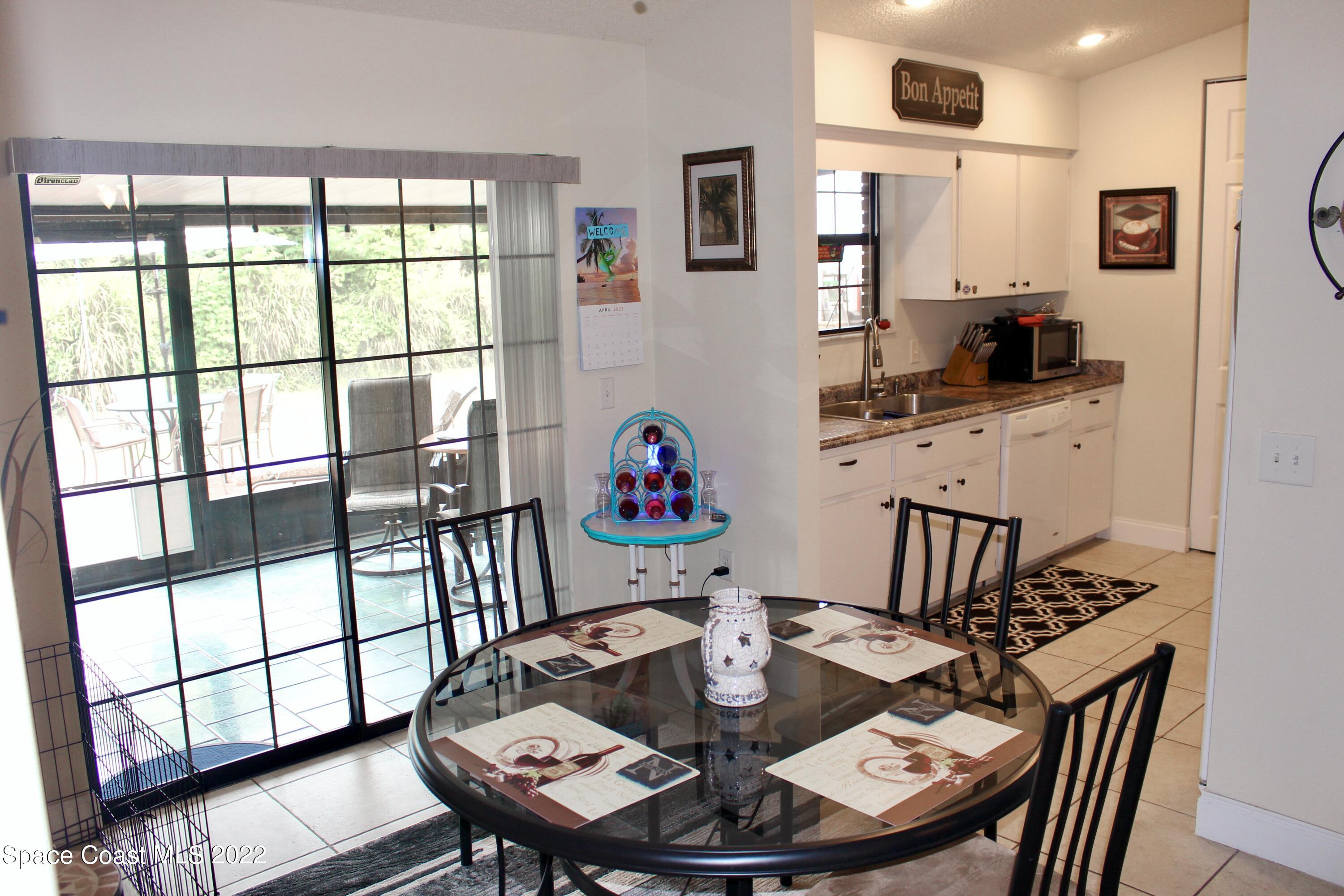 6737 Cecil Road Cocoa, FL 32927 - Photo 7 of 39 a view of a dining room with furniture window and wooden floor
