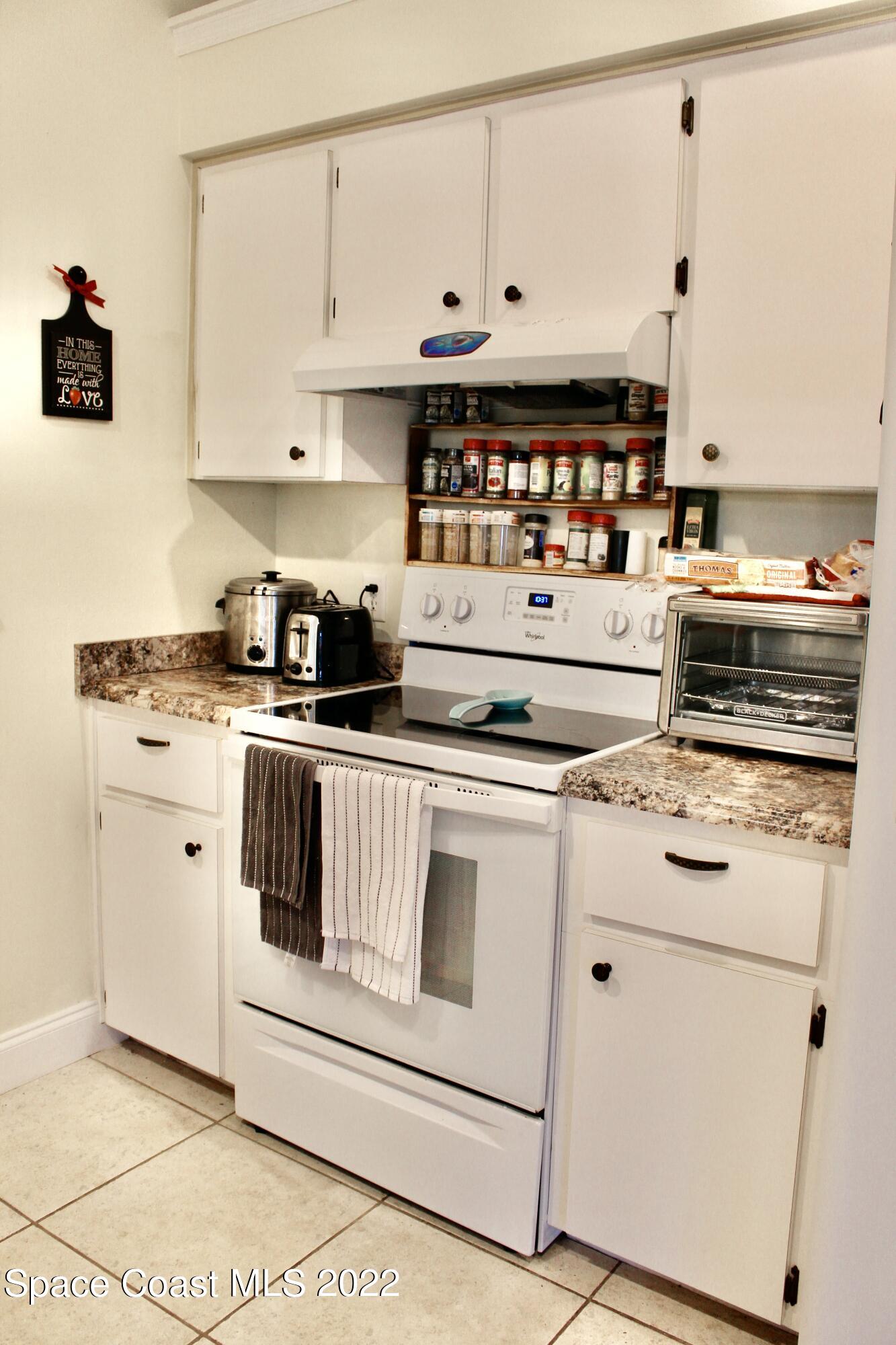 6737 Cecil Road Cocoa, FL 32927 - Photo 10 of 39 a kitchen with cabinets appliances and a counter space