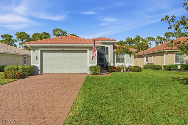 a front view of a house with a yard and garage