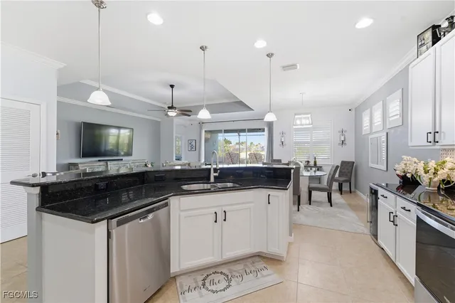 a kitchen with granite countertop a sink and cabinets