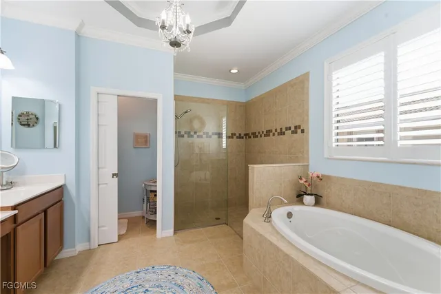 a spacious bathroom with a tub a sink and mirror