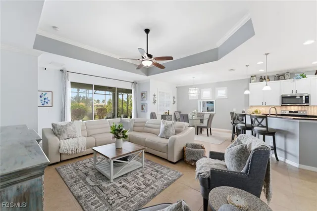 a living room with furniture and a chandelier