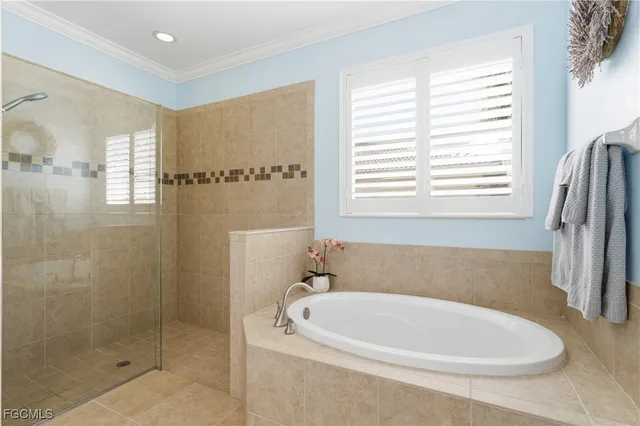 a white bath tub sitting in a bathroom next to a window