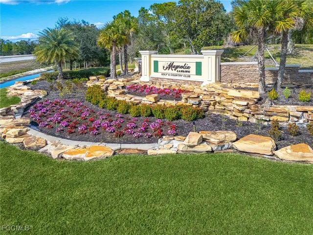 a view of a backyard with table and chairs potted plants