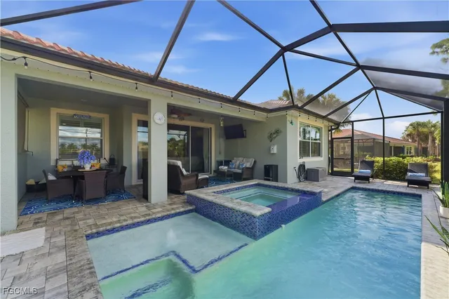 a view of a patio with a table and chairs under an umbrella
