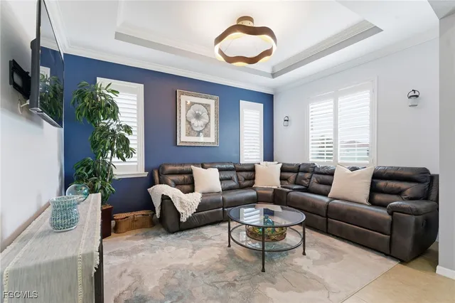 a living room with furniture potted plant and window