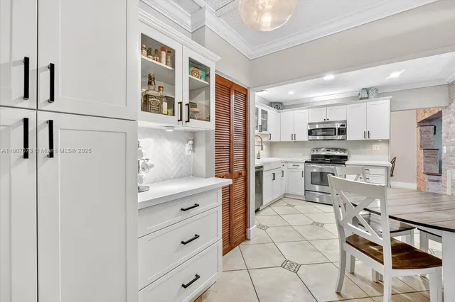 a kitchen with stainless steel appliances a refrigerator sink and cabinets