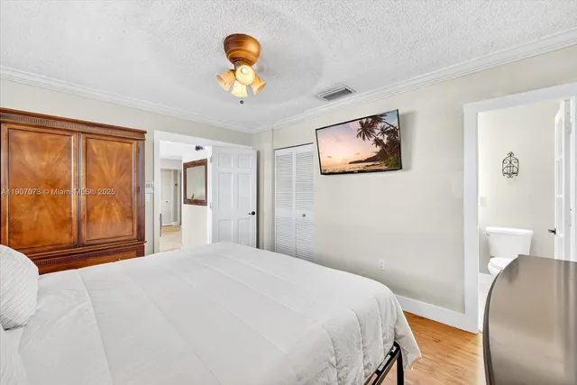 a bedroom with a bed and a painting on the wall