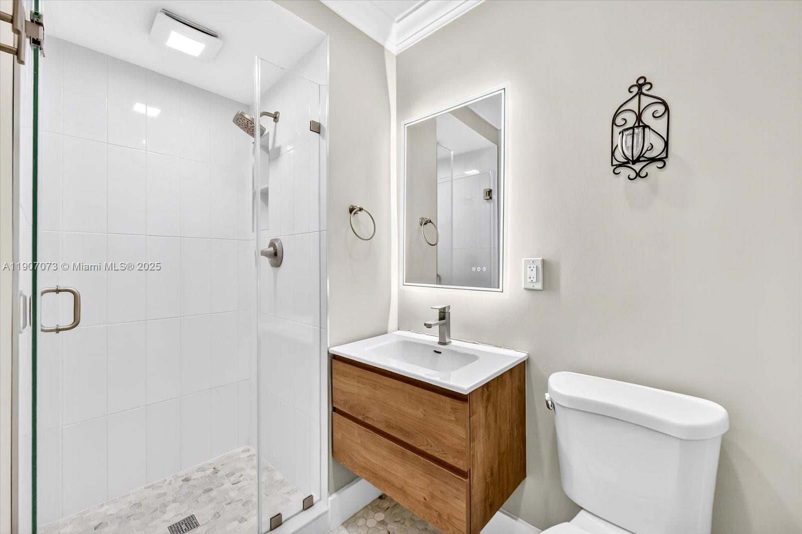 1300 West 77th Street Hialeah, FL 33014 - Photo 18 of 41 a bathroom with a sink mirror vanity and toilet