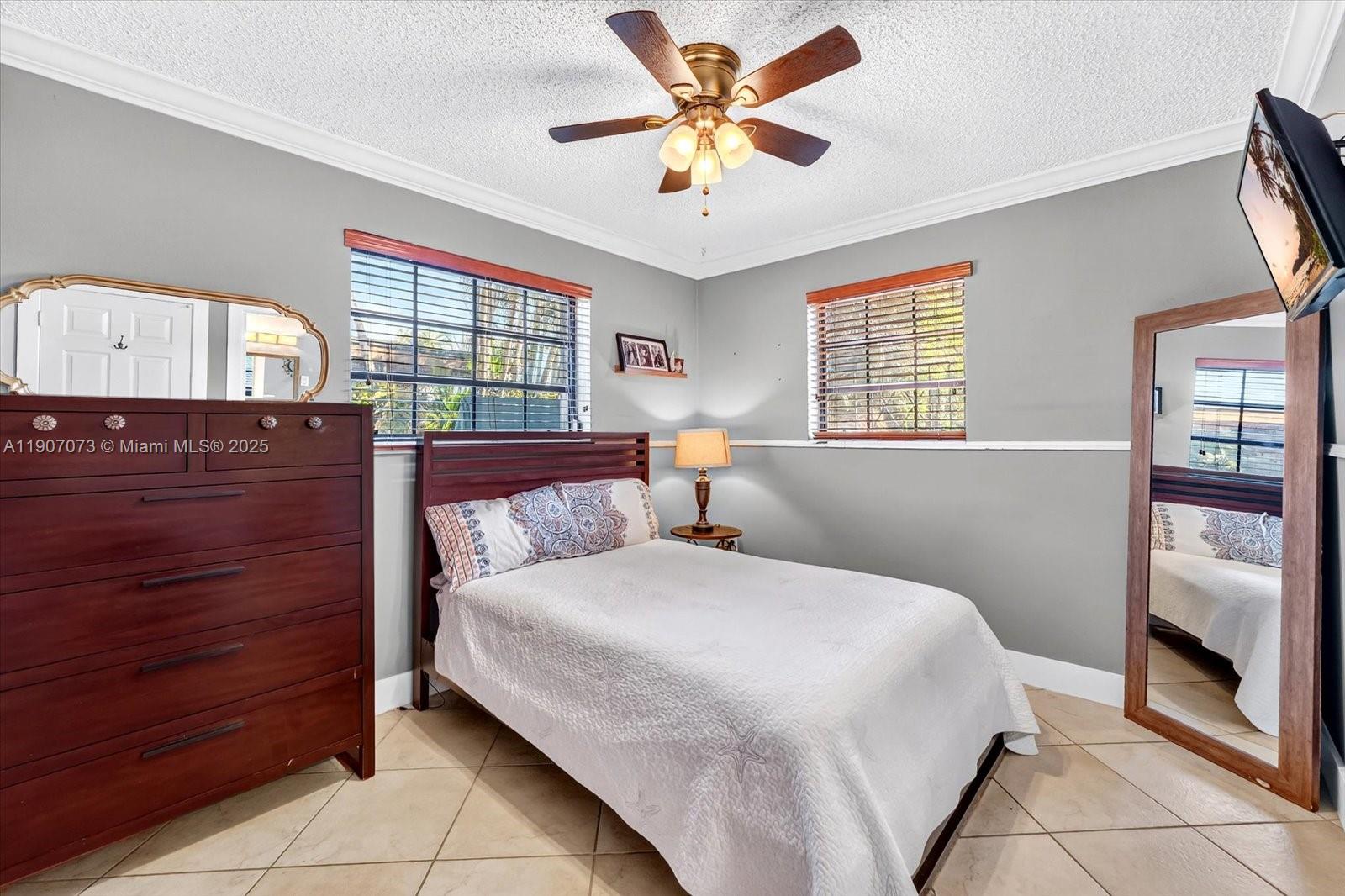 1300 West 77th Street Hialeah, FL 33014 - Photo 19 of 41 a bedroom with a bed and a window