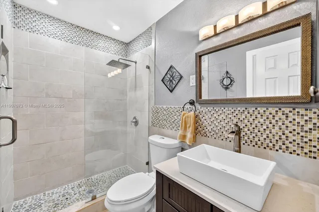 a bathroom with a toilet a sink and a shower