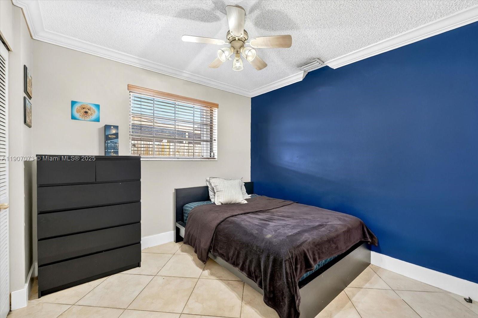 1300 West 77th Street Hialeah, FL 33014 - Photo 22 of 41 a bedroom with a bed and a chandelier