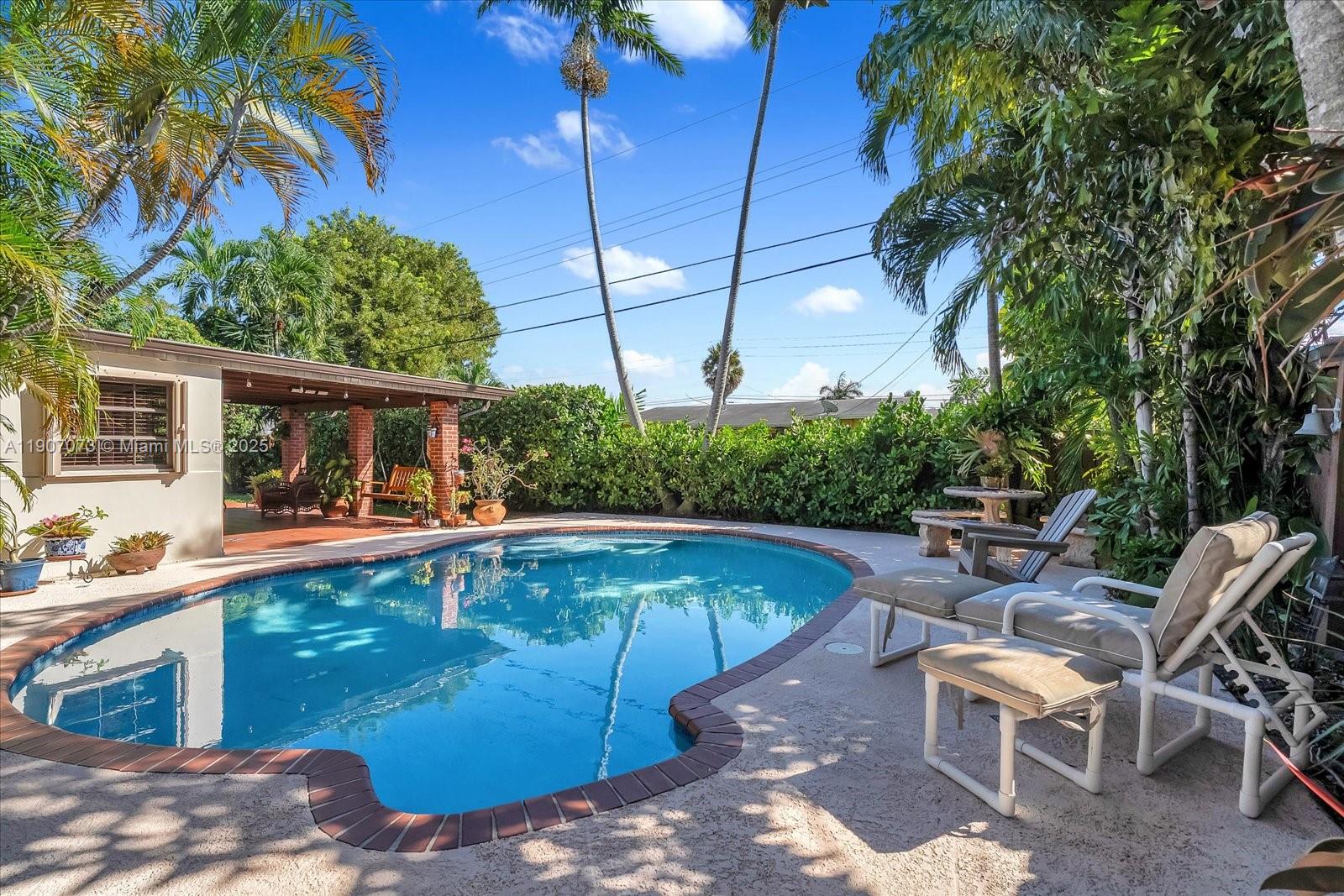1300 West 77th Street Hialeah, FL 33014 - Photo 27 of 41 a view of a swimming pool with chairs