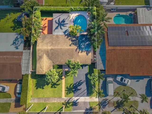 an aerial view of residential houses with yard
