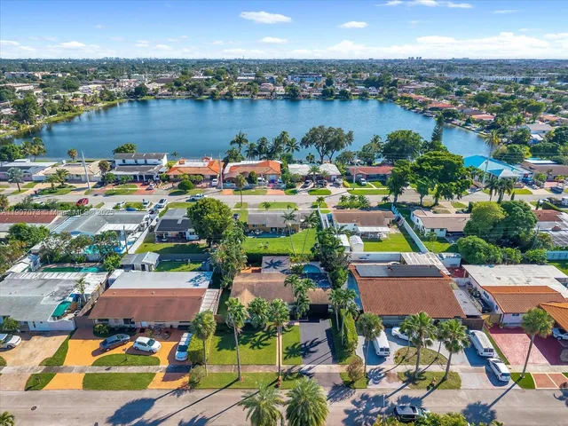 an aerial view of a houses with a lake view
