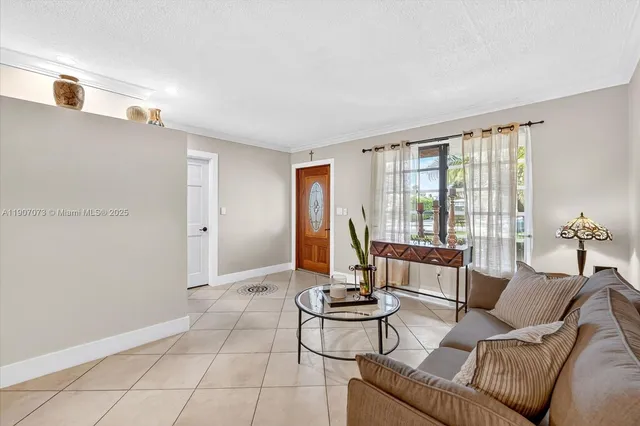 a living room with furniture and floor to ceiling windows