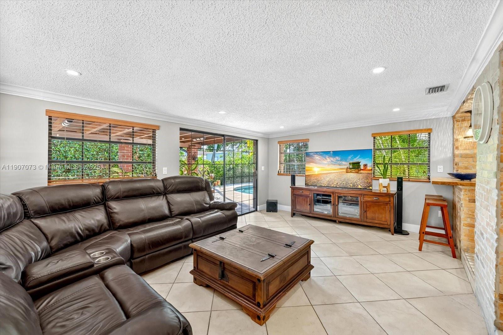 1300 West 77th Street Hialeah, FL 33014 - Photo 9 of 41 a living room with furniture and a flat screen tv