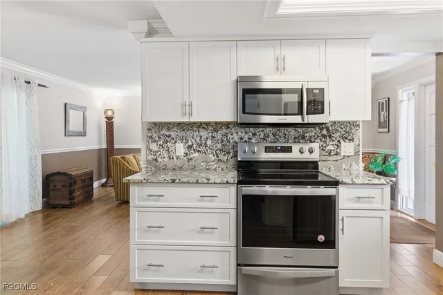 a kitchen with appliances a stove and a microwave