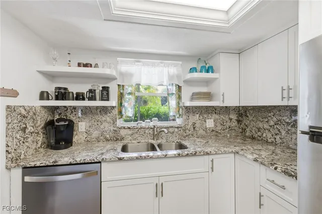 a kitchen with stainless steel appliances granite countertop a sink and cabinets