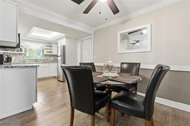 a view of a dining room with furniture and a chandelier