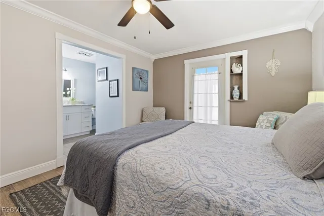 a bedroom with a large bed and wooden floor