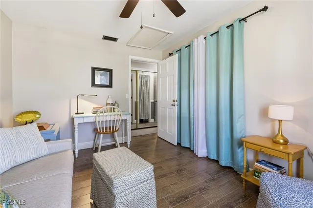 a bedroom with a bed a mirror and a window