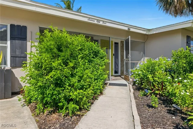 front view of a house with potted plants