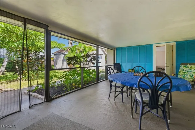 a dining room with furniture and a floor to ceiling window
