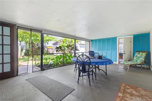 a view of a dining room with furniture and a window