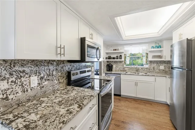 a kitchen with a refrigerator stove top oven and sink