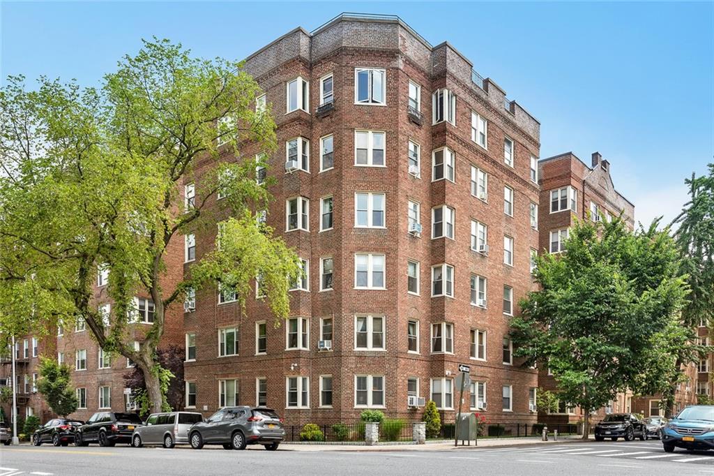 9281 Shore Road, Unit 608 Brooklyn, NY 11209 - Photo 12 of 13 a front view of a building with lot of cars and trees