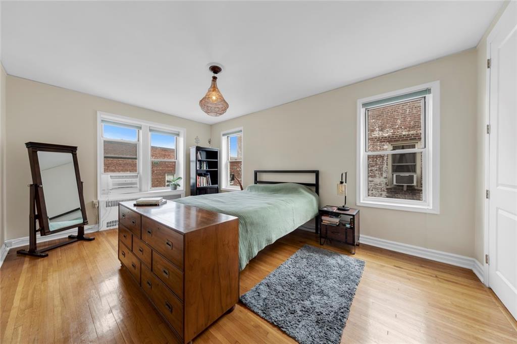 9281 Shore Road, Unit 608 Brooklyn, NY 11209 - Photo 6 of 13 a bed room with a bed and a window