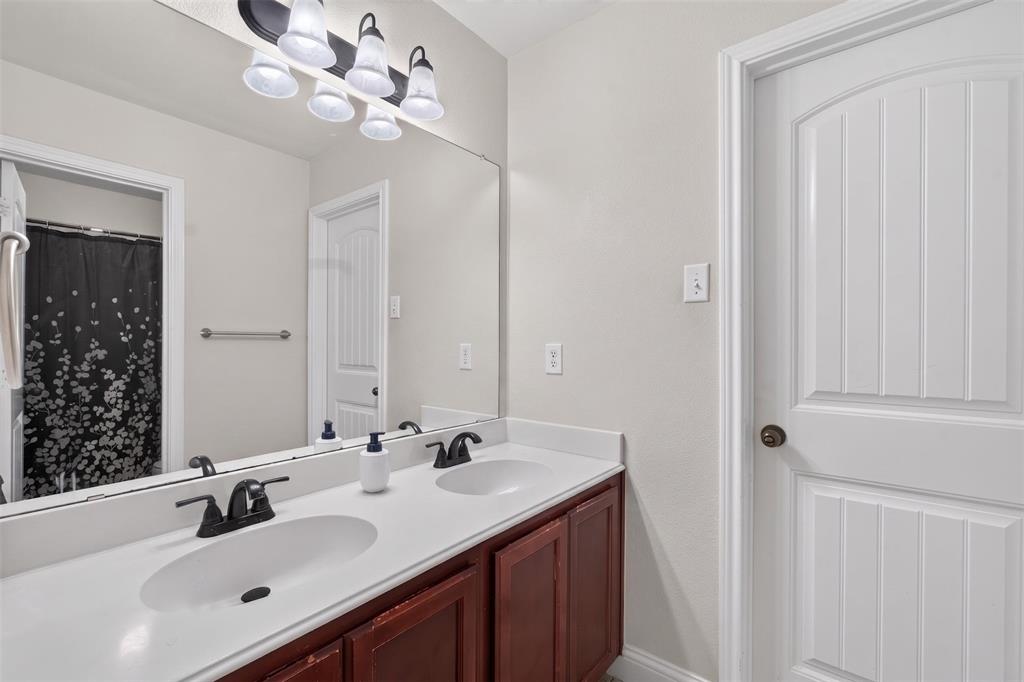 517 Austin Acre Road Sulphur Springs, TX 75482 - Photo 20 of 23 a bathroom with a sink vanity and a mirror