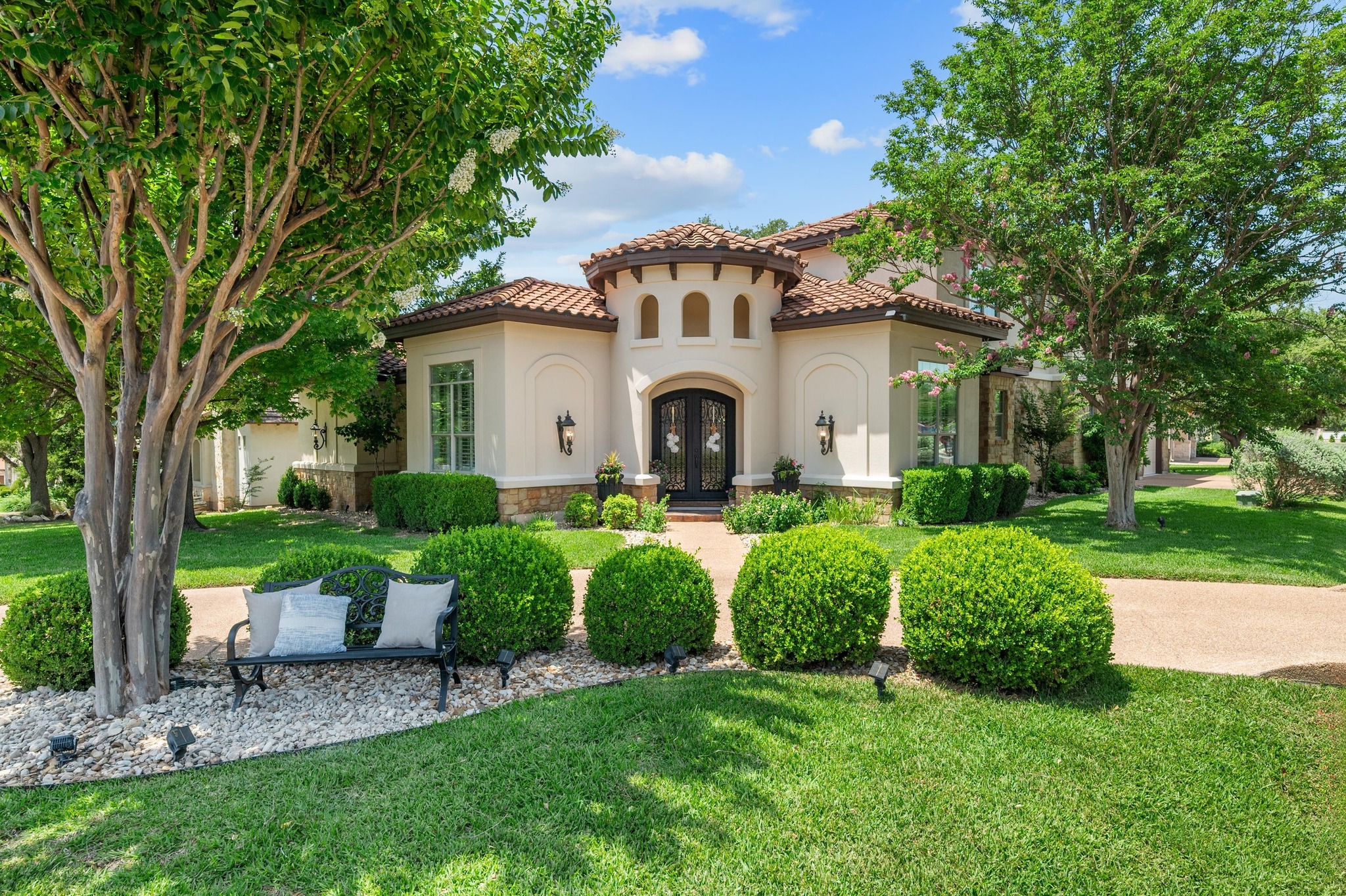 7 Sunview Road The Hills, TX 78738 - Photo 3 of 40 a front view of a house with porch and garden