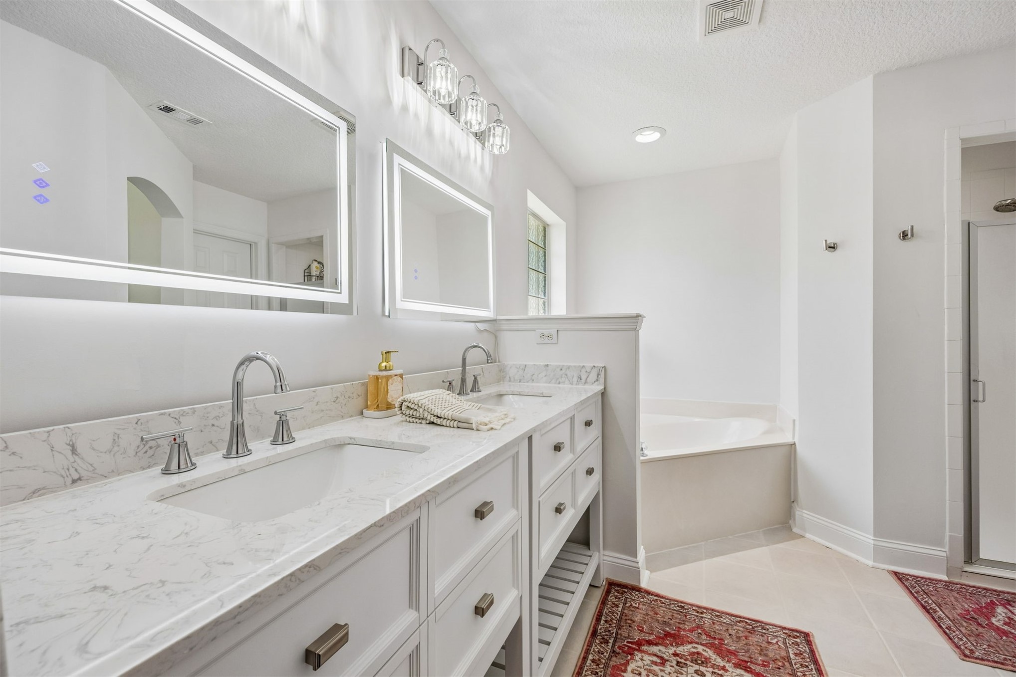 86107 Remsenburg Drive Fernandina Beach, FL 32034 - Photo 16 of 58 a spacious bathroom with a double vanity sink and mirror