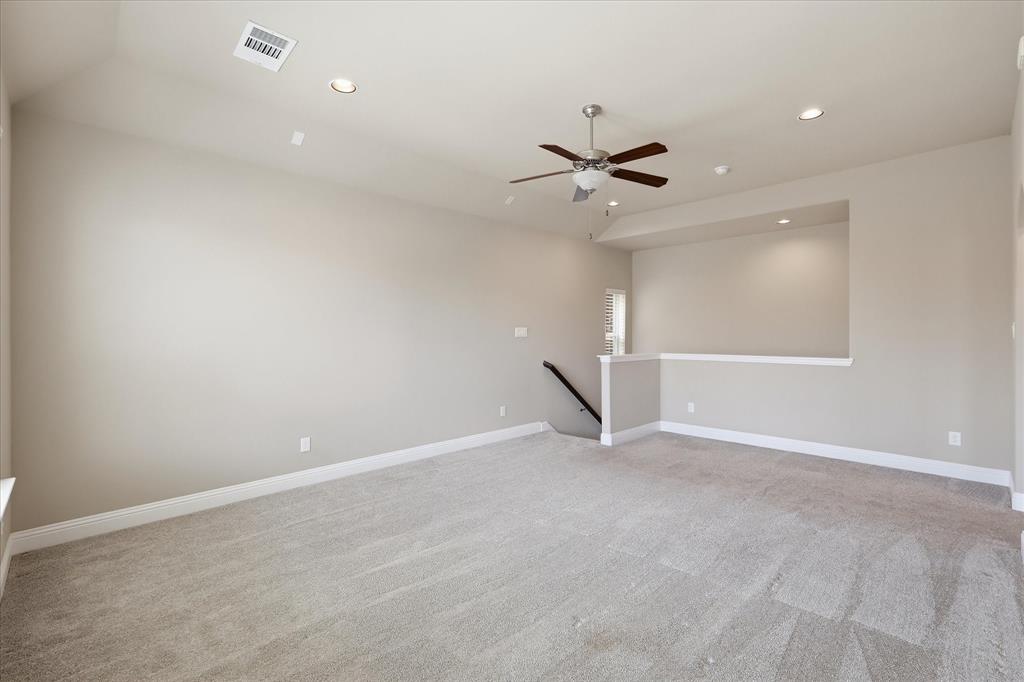 768 Huntingdon Street Coppell, TX 75019 - Photo 24 of 37 Large upstairs living area with neutral tones, soft carpet, and open wall space ready for a media setup, playroom, or home office zone.