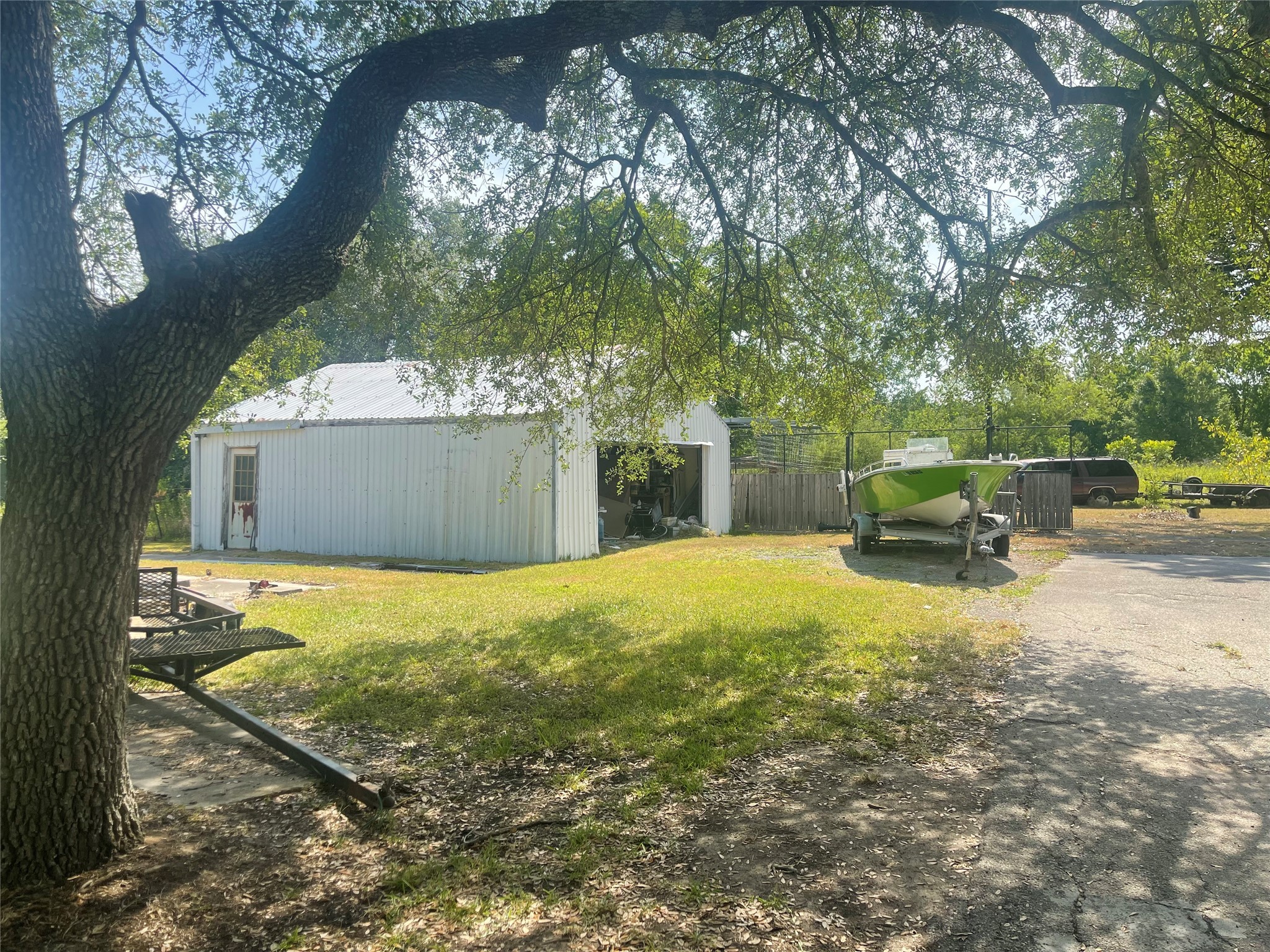 16719 McLean Road Pearland, TX 77584 - Photo 12 of 15 a backyard of a house with a yard and outdoor seating