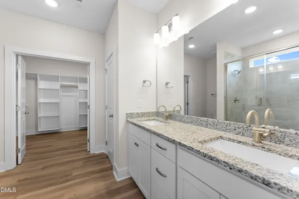 a bathroom with a granite countertop sink mirror and double