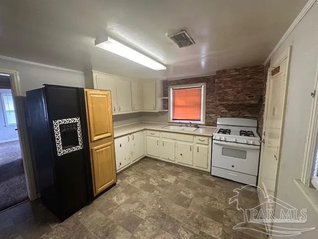 a kitchen with stainless steel appliances a refrigerator sink and cabinets