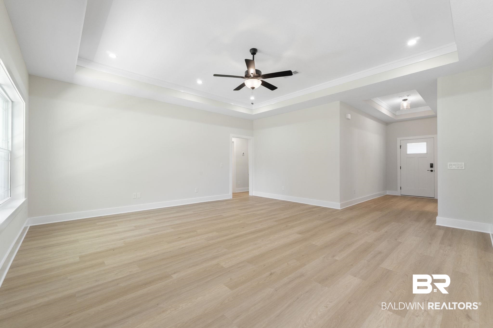 32563 Arbor Ridge Circle Lillian, AL 36549 - Photo 10 of 53 Empty room with a tray ceiling, light wood-style flooring, ornamental molding, ceiling fan, and recessed lighting