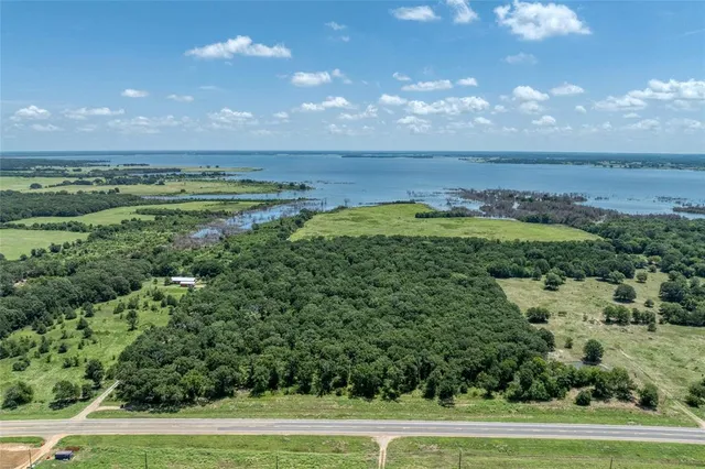 a view of a field with an ocean
