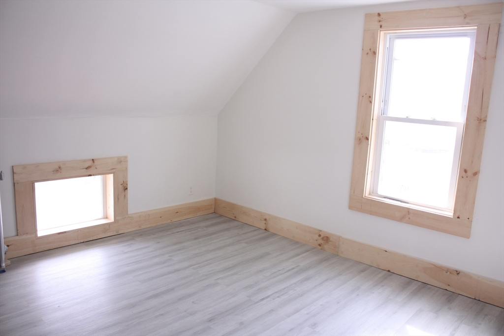 23 Foster Street Springfield, MA 01105 - Photo 11 of 15 an empty room with wooden floor and windows