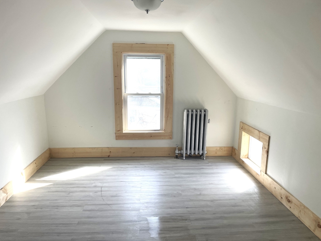 23 Foster Street Springfield, MA 01105 - Photo 12 of 15 an empty room with wooden floor and windows
