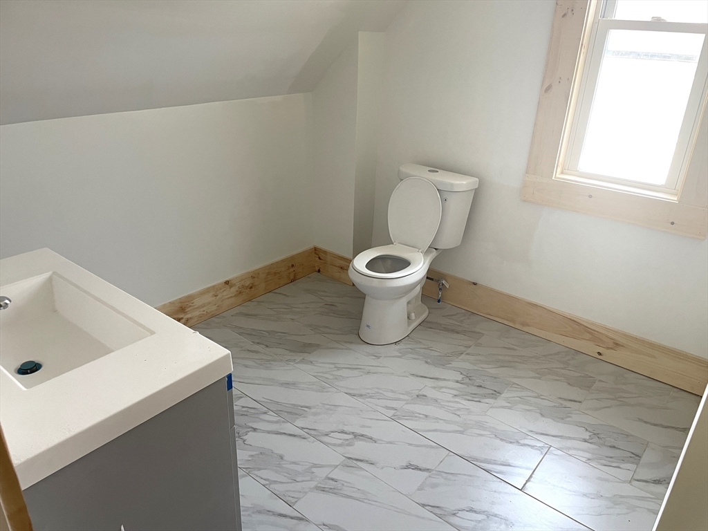 23 Foster Street Springfield, MA 01105 - Photo 13 of 15 a white toilet sitting next to a bathroom sink