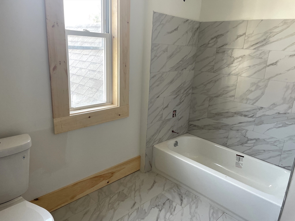 23 Foster Street Springfield, MA 01105 - Photo 14 of 15 a white bath tub sitting next to a white toilet