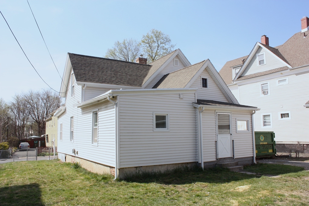 23 Foster Street Springfield, MA 01105 - Photo 2 of 15 a view of a white house next to a yard with big trees