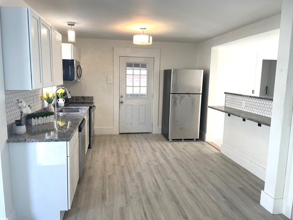 23 Foster Street Springfield, MA 01105 - Photo 4 of 15 a kitchen with refrigerator and window